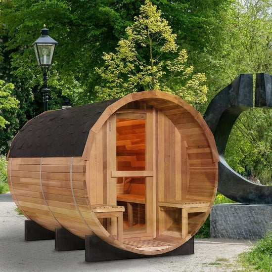 Elevate Performance Systems 6-person outdoor barrel sauna made of Canadian red cedar with a glass door and front porch