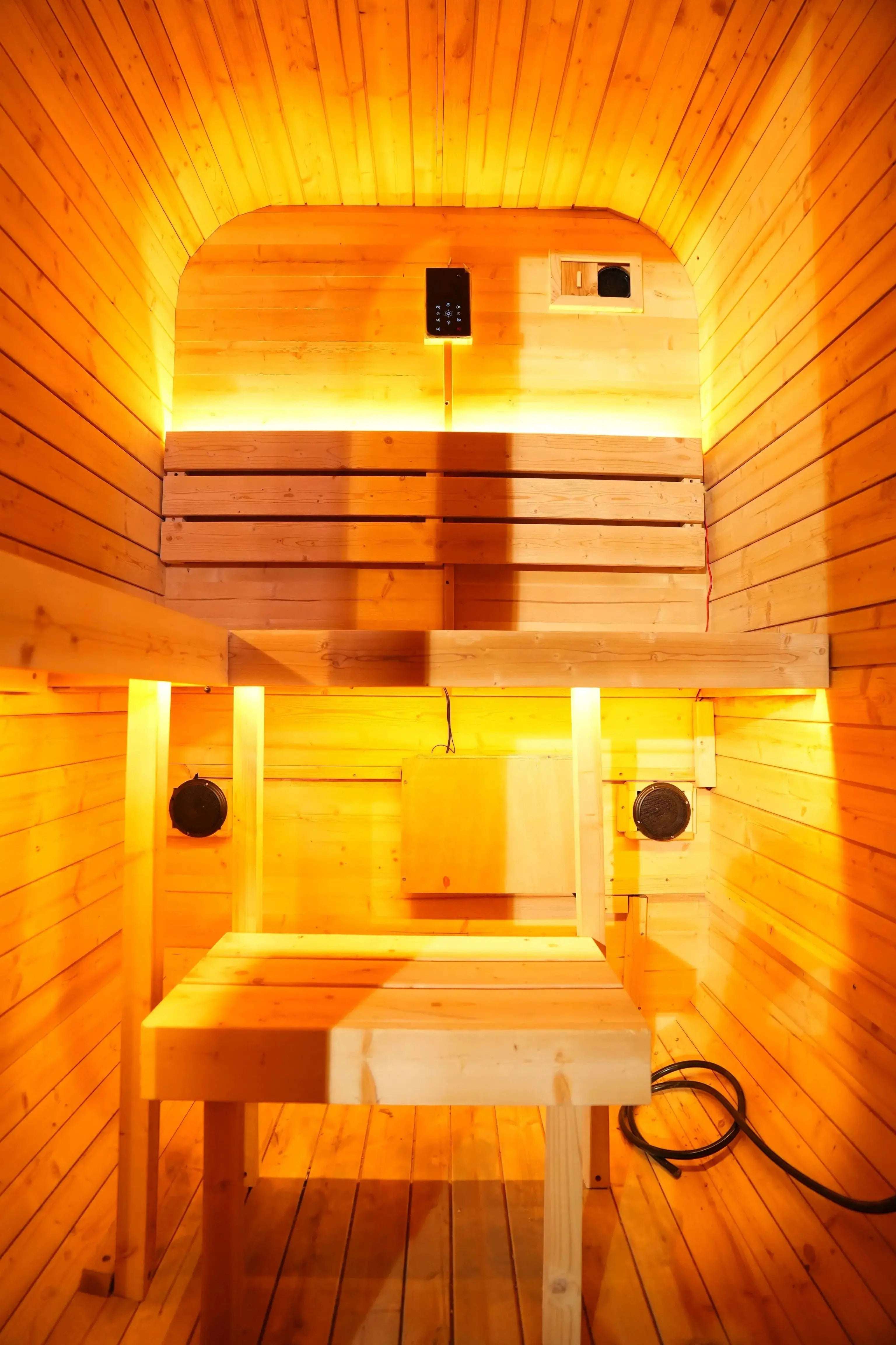 Interior of Elevate Performance Systems Ember Mini sauna featuring light wood paneling, bench seating, and warm lighting.