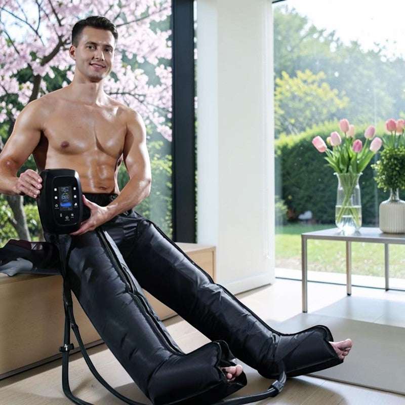 Elevate Performance Systems Flow Recovery Boots on a man using the digital control unit for leg muscle recovery