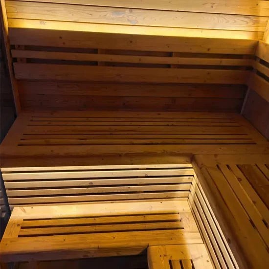 Elevate Performance Systems Noir Cube Sauna interior featuring L-shaped alder wood benches and warm LED lighting