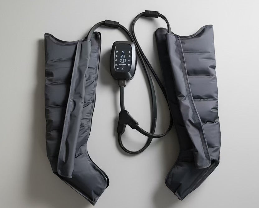 Elevate Performance Systems Pulse recovery boots in grey with a central digital control unit and air hoses.