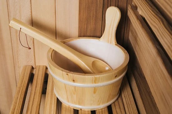 Elevate Performance Systems wooden sauna bucket and ladle set inside a natural red cedar sauna room