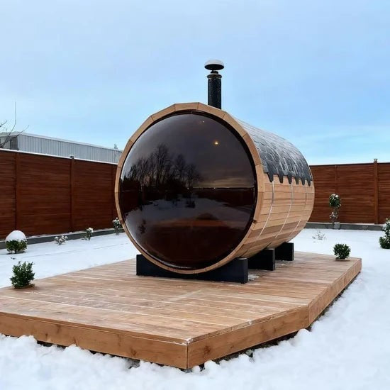 Elevate Performance Systems Vista wood-fired barrel sauna with panoramic glass in a snowy backyard setting.