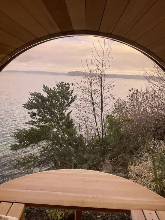 Elevate Performance Systems Vista wood fired sauna interior view featuring a panoramic glass wall overlooking a lake